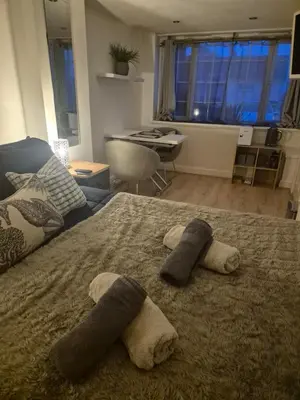 a bedroom with a bed with two towels on it at Number 6 in St Austell