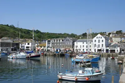 a group of boats are docked in a harbor at Harbourside Apartment in Mevagissey