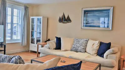 a living room with a couch and a table at Harbourside Apartment in Mevagissey
