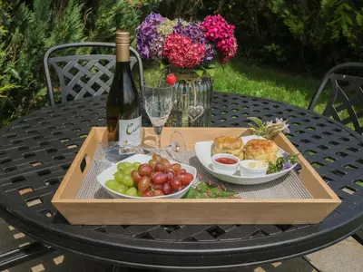 a tray of fruit and a bottle of wine on a table at The Hayloft in Liskeard
