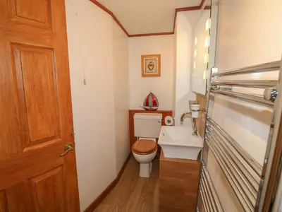 a small bathroom with a toilet and a sink at The Hayloft in Liskeard