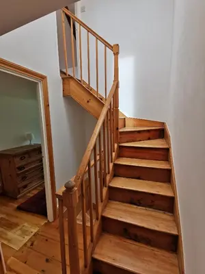 a staircase in a house with wooden floors at THE OLD RECTORY GLEBE HOUSE in Jacobstow 10 mins to Widemouth bay and Crackington Haven,15 mins Bude,20 mins tintagel, 27 mins Port Issac in Bude