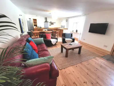 a living room with a couch and a table at THE OLD RECTORY GLEBE HOUSE in Jacobstow 10 mins to Widemouth bay and Crackington Haven,15 mins Bude,20 mins tintagel, 27 mins Port Issac in Bude
