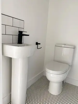 a bathroom with a white sink and a toilet at Seaporth Studio St Ives in St Ives