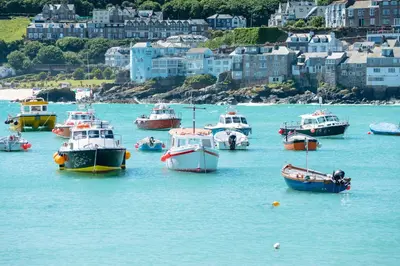 a group of boats in the water near a city at Seaporth Studio St Ives in St Ives