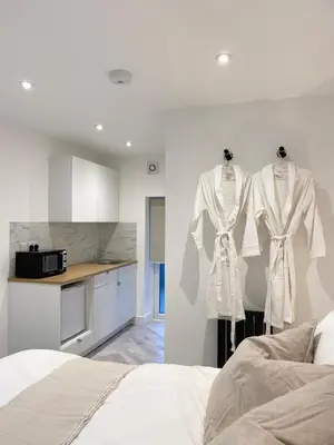 a bedroom with two mannequins in a kitchen at Seaporth Studio St Ives in St Ives