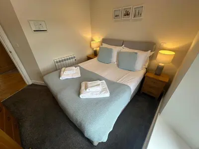 a bedroom with a bed with two towels on it at The Old Bakery in Fowey