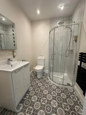 a bathroom with a shower and a toilet and a sink at The Old Bakery in Fowey