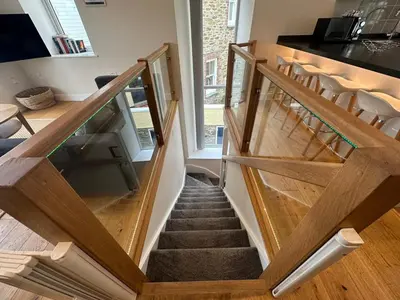 a staircase in a house with wooden railings at The Old Bakery in Fowey