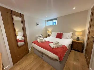 a bedroom with a bed with two towels on it at Crimpers Cottage in Fowey
