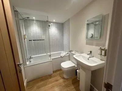 a bathroom with a sink and a toilet and a shower at Crimpers Cottage in Fowey