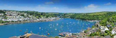 a view of a river with boats in a town at Crimpers Cottage in Fowey