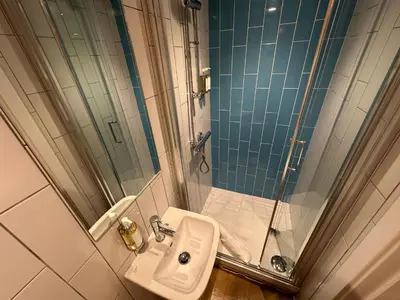 a bathroom with a sink and a shower at Crimpers Cottage in Fowey