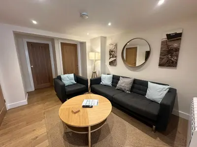 a living room with a couch and a table at Crimpers Cottage in Fowey