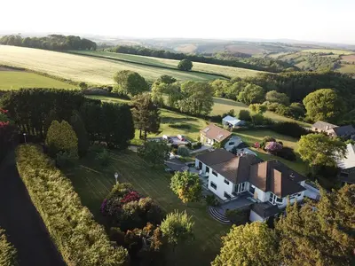 an aerial view of a house in a field at The Gate Cornwall in Looe