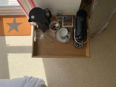 a wooden table with cups and appliances on it at The Gate Cornwall in Looe