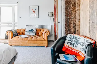 a living room with a couch and a chair at The Gate Cornwall in Looe