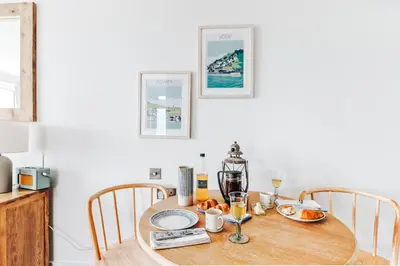 a dining room table with a coffee maker on it at The Gate Cornwall in Looe