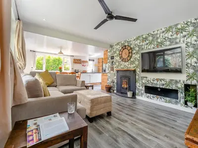 a living room with a couch and a fireplace at By The Beach- Uk31201 in Downderry
