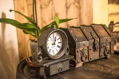 a group of trunks with a clock on a table at Deluxe Pirate's Cove Themed Apartment in St Austell