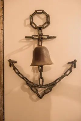a bell is hanging on a wall at Deluxe Pirate's Cove Themed Apartment in St Austell