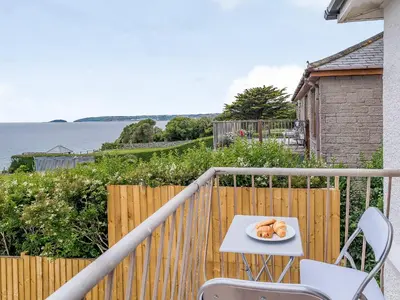 a plate of food on a table on a balcony at Beachside, West Yardley House - Uk31200 in Downderry
