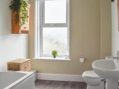 a bathroom with a sink toilet and a window at Beach View in Newquay