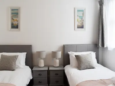 two beds sitting next to each other in a bedroom at Beach View in Newquay