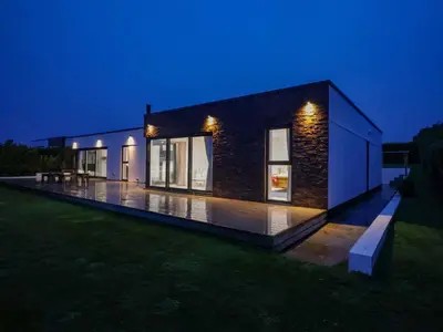 a small house at night with the lights on at Atlantic View in Penzance
