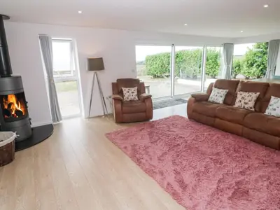 a living room with a couch and a fireplace at Atlantic View in Penzance