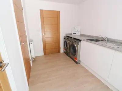 a laundry room with a washer and dryer at Atlantic View in Penzance