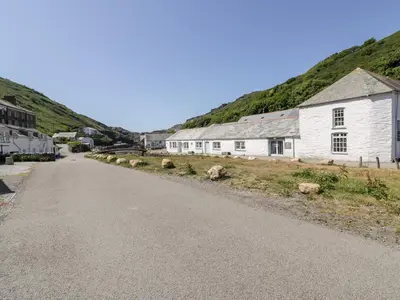 an empty road next to a white building at Harbour Cottage in Boscastle