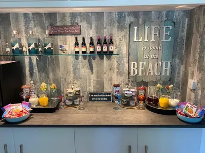 a bar with drinks and drinks on a counter at Toppesfield House B&B in Bude