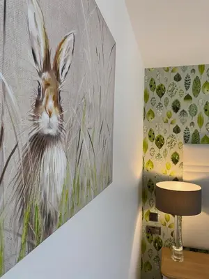 a painting of a rabbit on a wall next to a lamp at Toppesfield House B&B in Bude