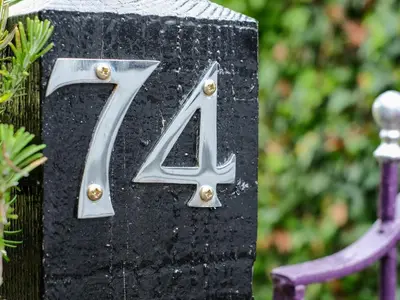 a black plaque with the number forty four at Lantern Cottage in St Austell