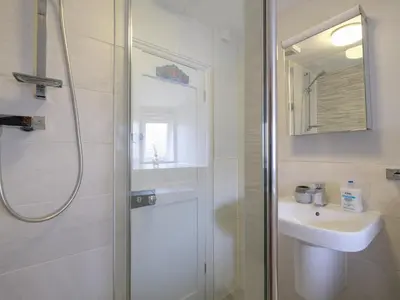 a bathroom with a shower and a sink at Lantern Cottage in St Austell
