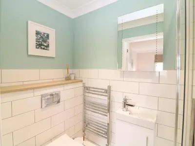 a bathroom with a sink and a mirror at Breakers in Newquay