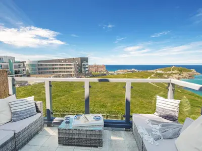 a balcony with two couches and a view of the ocean at Breakers in Newquay