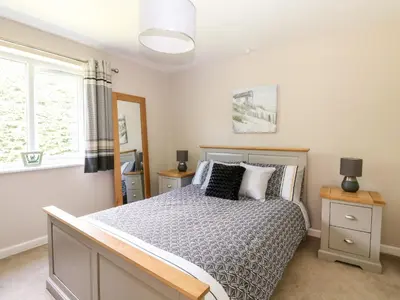 a bedroom with a bed and a window at Trevore Farmhouse in Truro