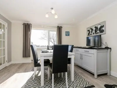 a kitchen and dining room with a table and chairs at Trevore Farmhouse in Truro