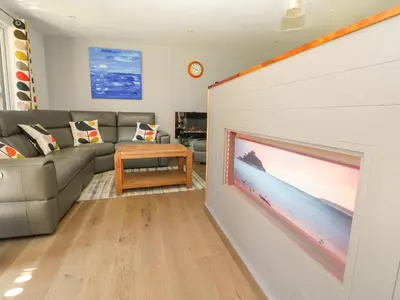 a living room with a large flat screen tv on a wall at 32 Trevithick in Hayle