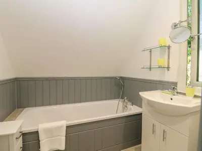 a bathroom with a bath tub and a sink at 32 Trevithick in Hayle