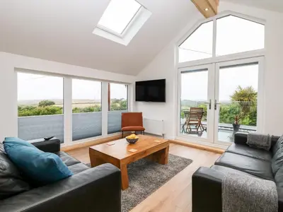 a living room with a couch and a table at Pen Chy in Helston