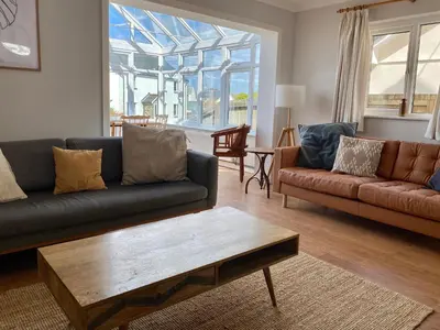 a living room with two couches and a coffee table at Auverne in Bude