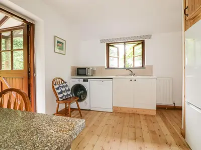 a kitchen with a sink and a microwave at Ribby Barn in Lostwithiel