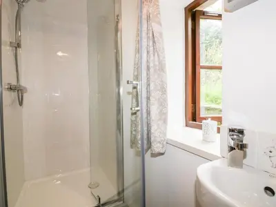 a bathroom with a shower and a sink at Ribby Barn in Lostwithiel