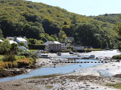 a body of water with boats in a river at Ribby Barn in Lostwithiel
