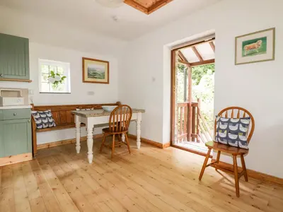 a kitchen and dining room with a table and chairs at Ribby Barn in Lostwithiel