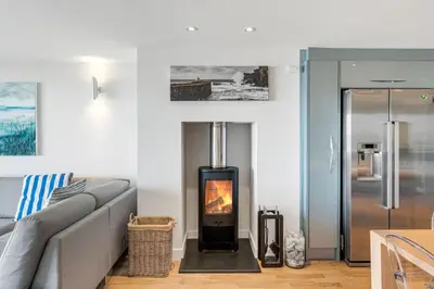 a living room with a couch and a fireplace at SeaEsta in Portreath