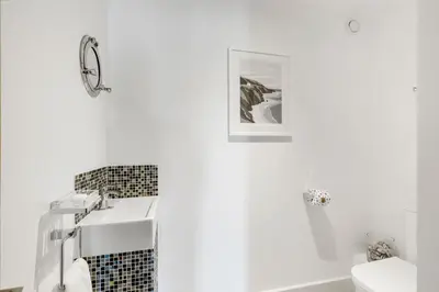 a white bathroom with a sink and a toilet at SeaEsta in Portreath